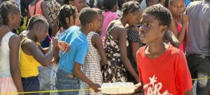 image1170x530cropped - Caribbean Television Network CAPAC/Jean Vadler Presume Children in Haiti line up for a hot meal and water distributed by the World Food Programme (WFP) in Port-au-Prince.