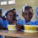 WFP/Pedro Rodrigues Children in Haiti eat a hot meal provided by the UN and partners at school