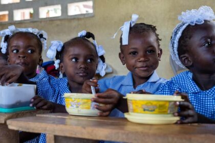 WFP/Pedro Rodrigues Children in Haiti eat a hot meal provided by the UN and partners at school