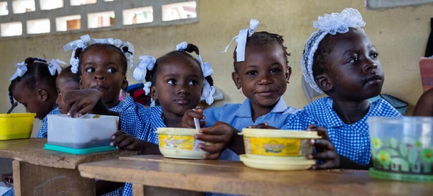 WFP/Pedro Rodrigues Children in Haiti eat a hot meal provided by the UN and partners at school