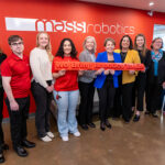 "Massachusetts Gov. Maura Healey (blue jacket, center), with Lt. Gov. Kimberly Driscoll, MassTech CEO Carolyn Kirk, Undersecretary of Economic Foundations Ashley Stolba, and MassRobotics’ team in Boston. Source: Office of the Governor"