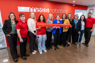 "Massachusetts Gov. Maura Healey (blue jacket, center), with Lt. Gov. Kimberly Driscoll, MassTech CEO Carolyn Kirk, Undersecretary of Economic Foundations Ashley Stolba, and MassRobotics’ team in Boston. Source: Office of the Governor"