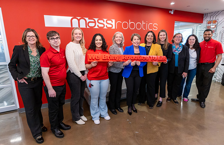 "Massachusetts Gov. Maura Healey (blue jacket, center), with Lt. Gov. Kimberly Driscoll, MassTech CEO Carolyn Kirk, Undersecretary of Economic Foundations Ashley Stolba, and MassRobotics’ team in Boston. Source: Office of the Governor"