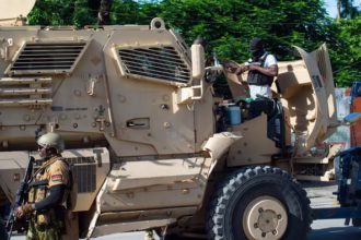 Kenyan police officers are seen leaving an armored vehicle Credit: AFP