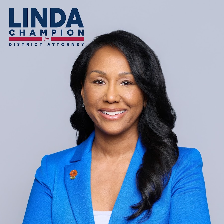 Portrait of Linda Champion smiling in a blue blazer, with campaign logo 'LINDA CHAMPION for District Attorney' top-left.